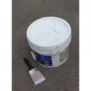 Five-gallon pail of paint with brush